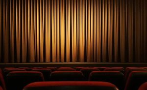 Rows of seats in a theater with the curtain drawn on the stage. | Fun activities around Little Rock, AR.