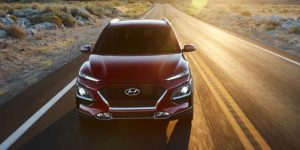 A red 2021 Hyundai Kona being driven on the road. | Hyundai dealer in Little Rock, AR.