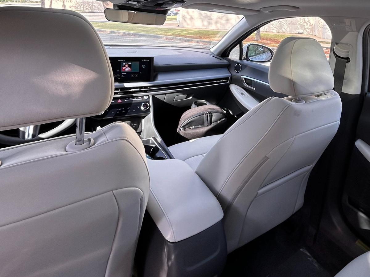 Interior view of a Hyundai sedan at Crain Hyundai of Little Rock, featuring modern technology, light upholstery, and a digital touchscreen display.